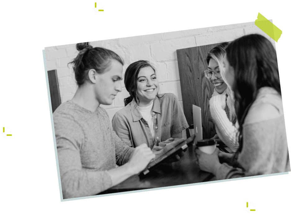 Four people talking around a tablet