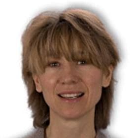 Naomi Fineberg, smiling to camera against a plain background